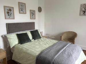 a bedroom with a bed and two chairs at Comfortable room in Newbridge