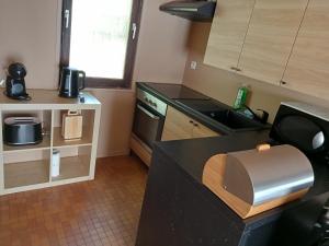 a kitchen with a black counter top and a sink at La petite maison 34 in Waulsort