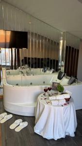 a bath tub with a table in front of it at Waves hotel in Avcılar