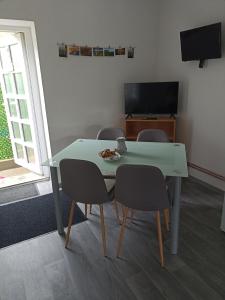 a table with chairs and a plate of food on it at Apartmán Slepička in Weissbach