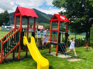 a group of children playing on a playground at Penzion Larion in Kráľová Lehota