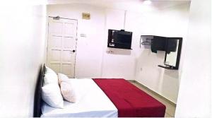 a bedroom with a bed with a red blanket at Hotel Lii View in Mersing