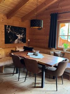 a dining room with a wooden table and chairs at Berglsteinersee 712er Lounge in Breitenbach am Inn