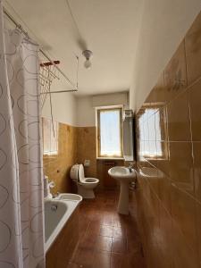 a bathroom with a tub and a sink and a toilet at Vecchio Mulino-Via Barale 40 in Entracque