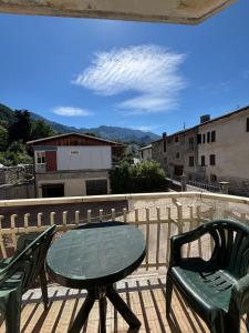 a patio with a table and chairs on a balcony at Vecchio Mulino-Via Barale 40 in Entracque
