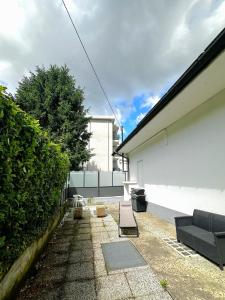 a patio with a couch on the side of a building at Smart Living Tavernerio in Tavernerio