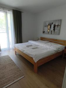 a bedroom with a large bed with white sheets at Apartment with parking in the city center in Staré Mesto