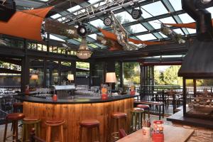 a bar in a restaurant with stools at Hotel Gasthof Kamml in Wals