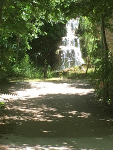 a waterfall in the middle of a dirt road at Camping-Hotel Los Molinos in Ruidera +12 photos