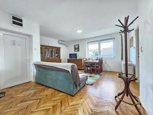 a bedroom with a bed and a dining room at Centar Apartman in Apatin