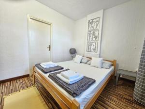a bedroom with a bed with towels on it at Centar Apartman in Apatin +4 photos