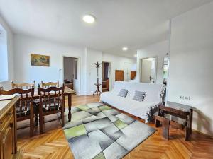 a bedroom with a bed and a table and a dining room at Centar Apartman in Apatin