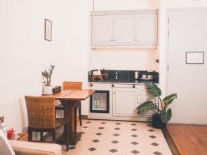 a kitchen with a table and a stove top oven at Yesterday Hotel in Chiang Mai