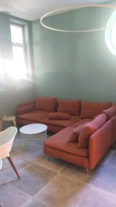 a living room with a couch and a table at Ostello Postumia in Torre deʼ Picenardi +2 photos