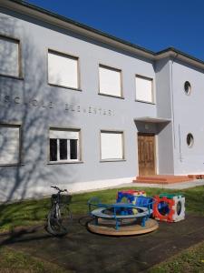 a bike parked in front of a building at Ostello Postumia in Torre deʼ Picenardi
