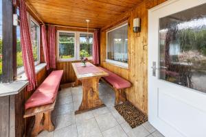 a small porch with a wooden table and benches at Ferienwohnung Miertsch in Oranienbaum-Wörlitz