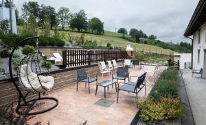 a patio with a bunch of chairs and tables at Kamiñone Landetxea in Beasain