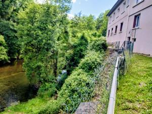 a building next to a river next to a building at bord de rivière in Accons