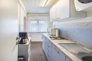 a kitchen with white cabinets and a counter top at Ferienwohnung Miertsch in Oranienbaum-Wörlitz +5 photos