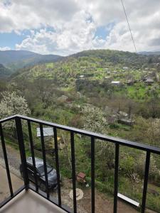a balcony with a car parked on a hill at hyuratun Shamlugh in Shamlugh