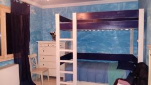 a bedroom with a bunk bed with a ladder at VillaOriental Valmontone in Genazzano