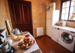 a kitchen with a table with a plate of donuts at La Casa de los Templarios in Puebla de Alcocer
