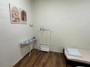 a room with a bed and a shelf in it at Permaisuri homestay in Bintulu