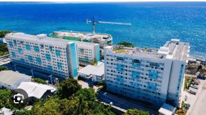 an aerial view of a large building by the ocean at Bienvenida Condotel in Dumaguete