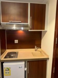 a small kitchen with a sink and a stove at فندق شعاع النزهة - مكة المكرمة in Mecca