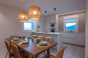 a kitchen and dining room with a wooden table and chairs at Kamiñone Landetxea in Beasain