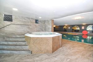 a bathroom with a hot tub and a swimming pool at 3 Bed in Penrith oc-85896 in Penruddock
