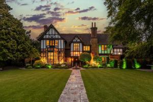 a large house with a green lawn at dusk at 12 Bed in Bournemouth oc-t28236 in Bournemouth