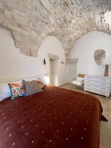a bedroom with a large bed with a stone ceiling at Casa Leo with Jacuzzi in Ostuni +18 photos