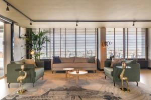a living room with a couch and a table at Leonardo Hotel IJmuiden Seaport Beach in IJmuiden +116 photos