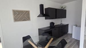 a dining room with a glass table and black chairs at Bella Vita Stays Wellness in Sondrio