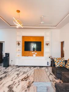 a living room with a flat screen tv on a wall at Diani Dream luxury apartment in Diani Beach