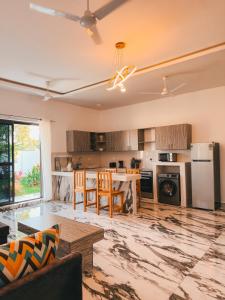 a living room with a kitchen with a table at Diani Dream luxury apartment in Diani Beach