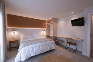 a bedroom with a large bed and a desk at Kamiñone Landetxea in Beasain