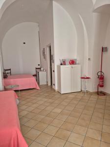 a large room with two beds and a tile floor at Dimora Suriano in Altamura