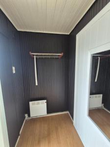 a room with black walls and a mirror at Cozy Home in Stokmarknes