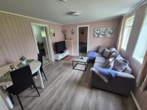 a living room with a couch and a table at Cozy Home in Stokmarknes