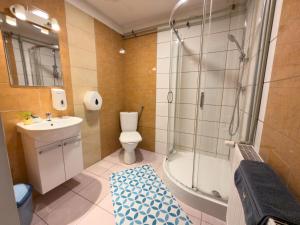 a bathroom with a shower and a toilet and a sink at Hostel Relax in Warsaw +35 photos