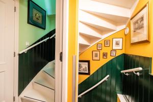 a staircase in a house with green and yellow walls at Hotel Bet van Beeren in Amsterdam +59 photos
