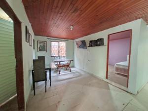 a dining room with a table and a bedroom at Hostal Puerto del Reino in Puerto Colombia