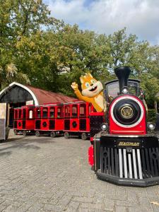 a small red train with a cartoon character on it at Koning te Rijk - Residence de Eese in De Bult