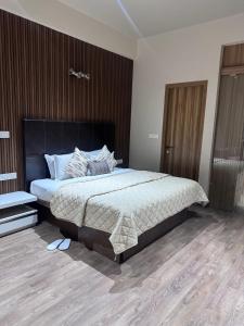 a bedroom with a large bed and a wooden floor at Rare Aura Villa in Dod Jāla +15 photos