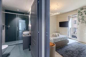 a bathroom with a bed and a shower and a sink at Dune Luxury Residence in Turin