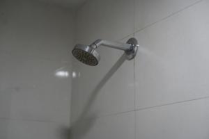 a shower with a shower head in a bathroom at Hotel Laasya Grand in Vijayawāda