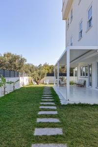 a garden with a stone path leading to a house at Cedori Butik Otel in Ezine