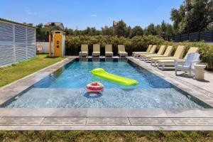a swimming pool with a pool noodle and a inflatable at Cedori Butik Otel in Ezine